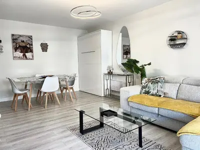 a living room with a couch and a table at Paradis in Cannes