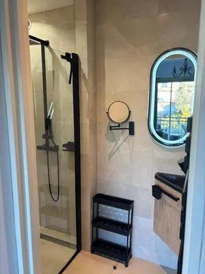 a bathroom with a shower and a sink and a window at Cannes Blue Riviera Luxe in Cannes