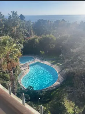 an overhead view of a swimming pool with the ocean in the background at Cannes Blue Riviera Luxe in Cannes