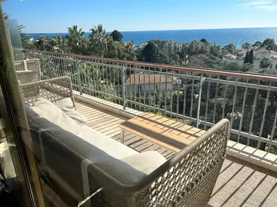 a balcony with a bench and a view of the ocean at Cannes Blue Riviera Luxe in Cannes