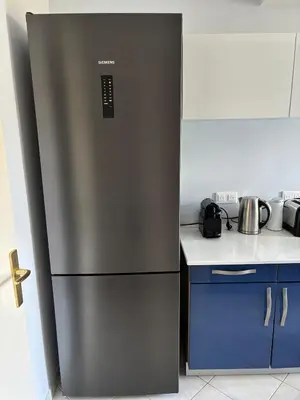 a stainless steel refrigerator in a kitchen at Cannes Blue Riviera Luxe in Cannes
