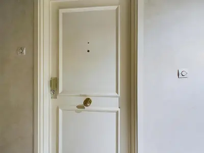 a white door with a gold door knob on it at Centre Cannes Suquet in Cannes