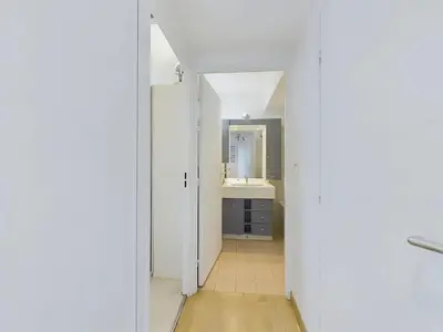 a hallway with a bathroom with a sink and a mirror at Centre Cannes Suquet in Cannes