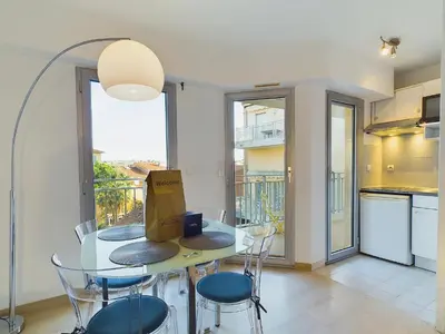 a kitchen and dining room with a table and chairs at Centre Cannes Suquet in Cannes