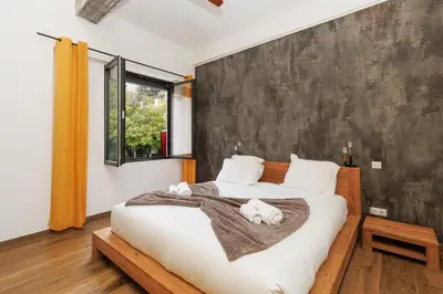a bedroom with a bed with two stuffed animals on it at Immogroom - Exceptional Villa Near Croisette in Cannes