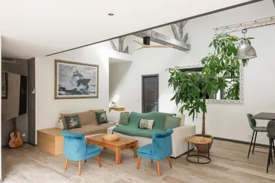 a living room with a couch and blue chairs at Immogroom - Exceptional Villa Near Croisette in Cannes