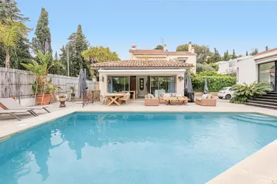 a swimming pool in front of a house at Immogroom - Exceptional Villa Near Croisette in Cannes