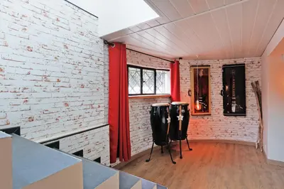 a room with a brick wall and two drums at Immogroom - Exceptional Villa Near Croisette in Cannes