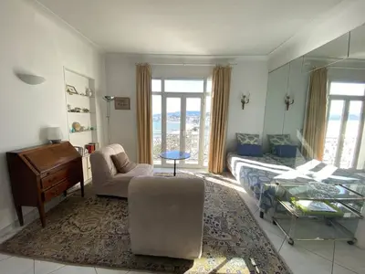 a living room with a bed and a piano at Cannes Croisette - 2 pièces vue mer in Cannes