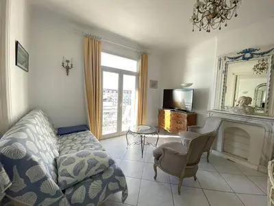 a living room with a couch and a fireplace at Cannes Croisette - 2 pièces vue mer in Cannes