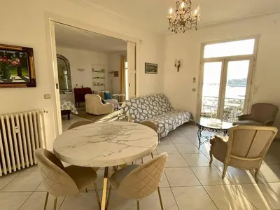 a living room with a table and a couch at Cannes Croisette - 2 pièces vue mer in Cannes