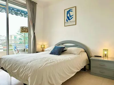 a bedroom with a large bed and a window at Nice 1 bedroom, sea view, 10 min from Cannes Center & Palais des Festivals in Cannes