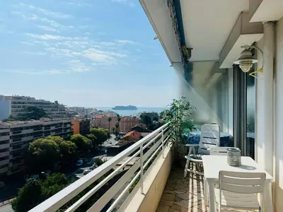 a balcony with a view of a city at Nice 1 bedroom, sea view, 10 min from Cannes Center & Palais des Festivals in Cannes