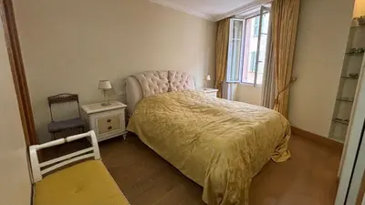 a small bedroom with a bed and a window at PORT DE CANNES SUPERBE 3 Pièces in Cannes