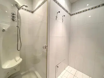 a white bathroom with a shower and a toilet at PORT DE CANNES SUPERBE 3 Pièces in Cannes