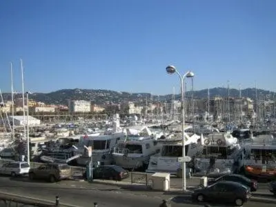 a marina with a bunch of boats in a harbor at PORT DE CANNES SUPERBE 3 Pièces in Cannes