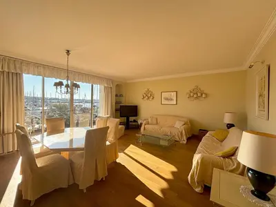 a living room with a table and a dining room at PORT DE CANNES SUPERBE 3 Pièces in Cannes