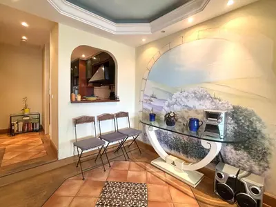 a living room with a glass table and two chairs at PORT DE CANNES SUPERBE 3 Pièces in Cannes