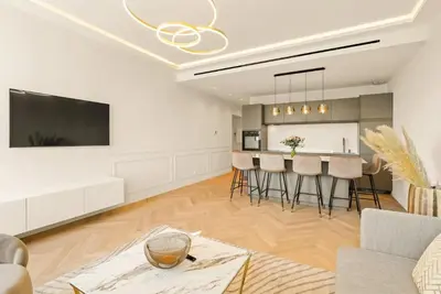 a living room with a kitchen and a dining room at LES SUITES DU PALAIS sur LA CROISETTE - Vue MER in Cannes