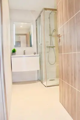 a bathroom with a glass shower and a sink at REF 2003 - Cannes Croisette - 3 mins from the Croissette in Cannes