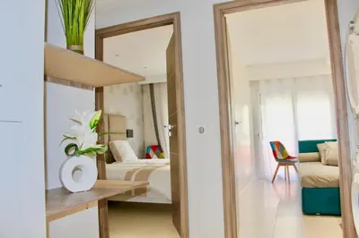 a room with a bedroom with a bed and a mirror at REF 2003 - Cannes Croisette - 3 mins from the Croissette in Cannes