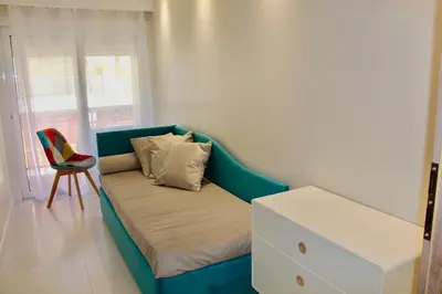 a couch in a room with a chair and a window at REF 2003 - Cannes Croisette - 3 mins from the Croissette in Cannes