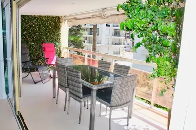 a patio with a glass table and chairs on a balcony at REF 2003 - Cannes Croisette - 3 mins from the Croissette in Cannes