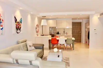 a living room and kitchen with a couch and chairs at REF 2003 - Cannes Croisette - 3 mins from the Croissette in Cannes