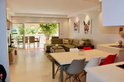 a kitchen and living room with a couch and a table at REF 2003 - Cannes Croisette - 3 mins from the Croissette in Cannes