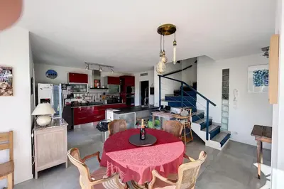 a kitchen and dining room with a red table and chairs at Peaceful villa with pool and garden - 5 minutes from Cannes beaches in Cannes