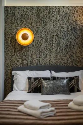 a bedroom with a bed with a orange light on the wall at Jessicannes - Architect loft near Croisette in Cannes
