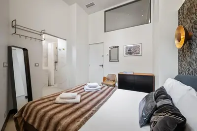 a bedroom with a bed with towels on it at Jessicannes - Architect loft near Croisette in Cannes