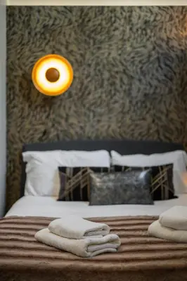 a bedroom with a bed with two towels on it at Jessicannes - Architect loft near Croisette in Cannes