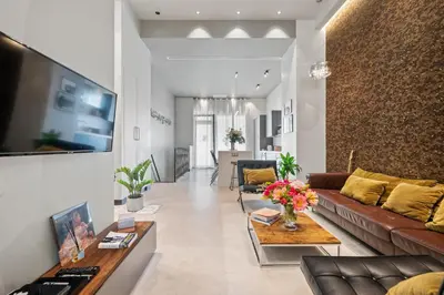 a living room with a couch and a table at Jessicannes - Architect loft near Croisette in Cannes