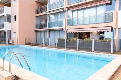 a swimming pool in front of a building at Cannes plage - avec terrasse, vue, mer, piscine, plage, garage in Cannes