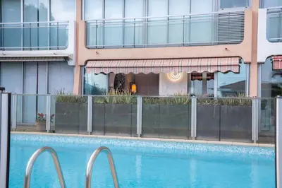 a swimming pool in front of a building at Cannes plage - avec terrasse, vue, mer, piscine, plage, garage in Cannes