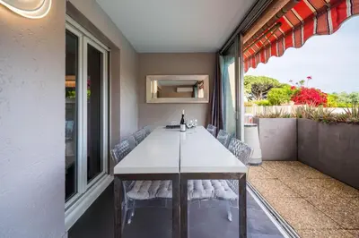 a dining room with a table and chairs at Cannes plage - avec terrasse, vue, mer, piscine, plage, garage in Cannes
