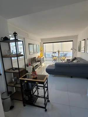 a large living room with a bed and a table at Center Cannes Hippocampe in Cannes