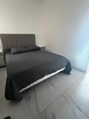 a bed in a white room with at La Pitchounette bord de mer in Cannes