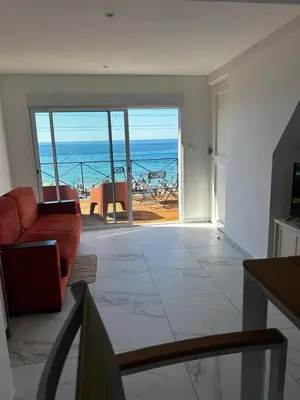 a living room with a view of the ocean at La Pitchounette bord de mer in Cannes