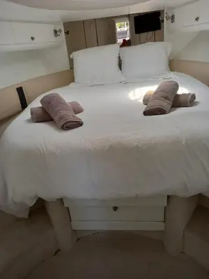 a large white bed with three pillows on it at yacht 17M Princess V52 Cannes port canto 3 chambres AC in Cannes