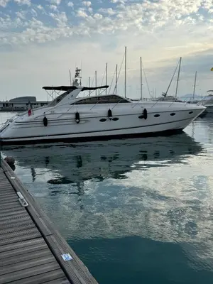 a white boat is docked next to a dock at yacht 17M Princess V52 Cannes port canto 3 chambres AC in Cannes
