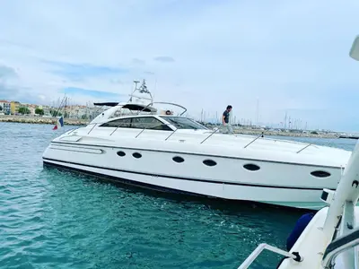 a white boat is docked in the water at yacht 17M Princess V52 Cannes port canto 3 chambres AC in Cannes