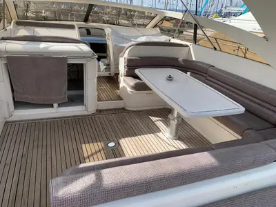 a deck of a boat with a table on it at yacht 17M Princess V52 Cannes port canto 3 chambres AC in Cannes