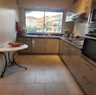 a kitchen with a sink and a window at Center Cannes Montfleury in Cannes