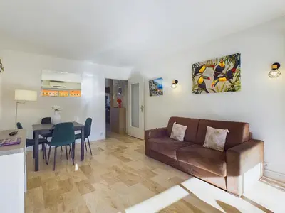a living room with a couch and a table at Center Cannes Montfleury in Cannes