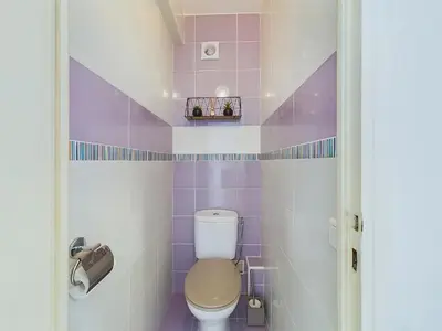 a purple and white bathroom with a toilet at Center Cannes Montfleury in Cannes