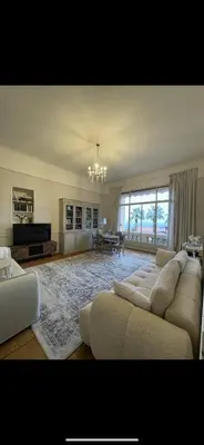 a large living room with a couch and a table at Parc Continental Apartment with sea view in Cannes