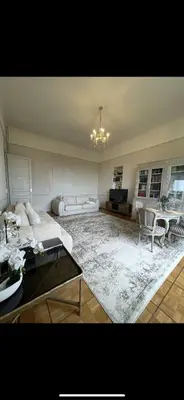 a living room with a couch and a table at Parc Continental Apartment with sea view in Cannes