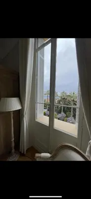 a room with a window with a view of the ocean at Parc Continental Apartment with sea view in Cannes
